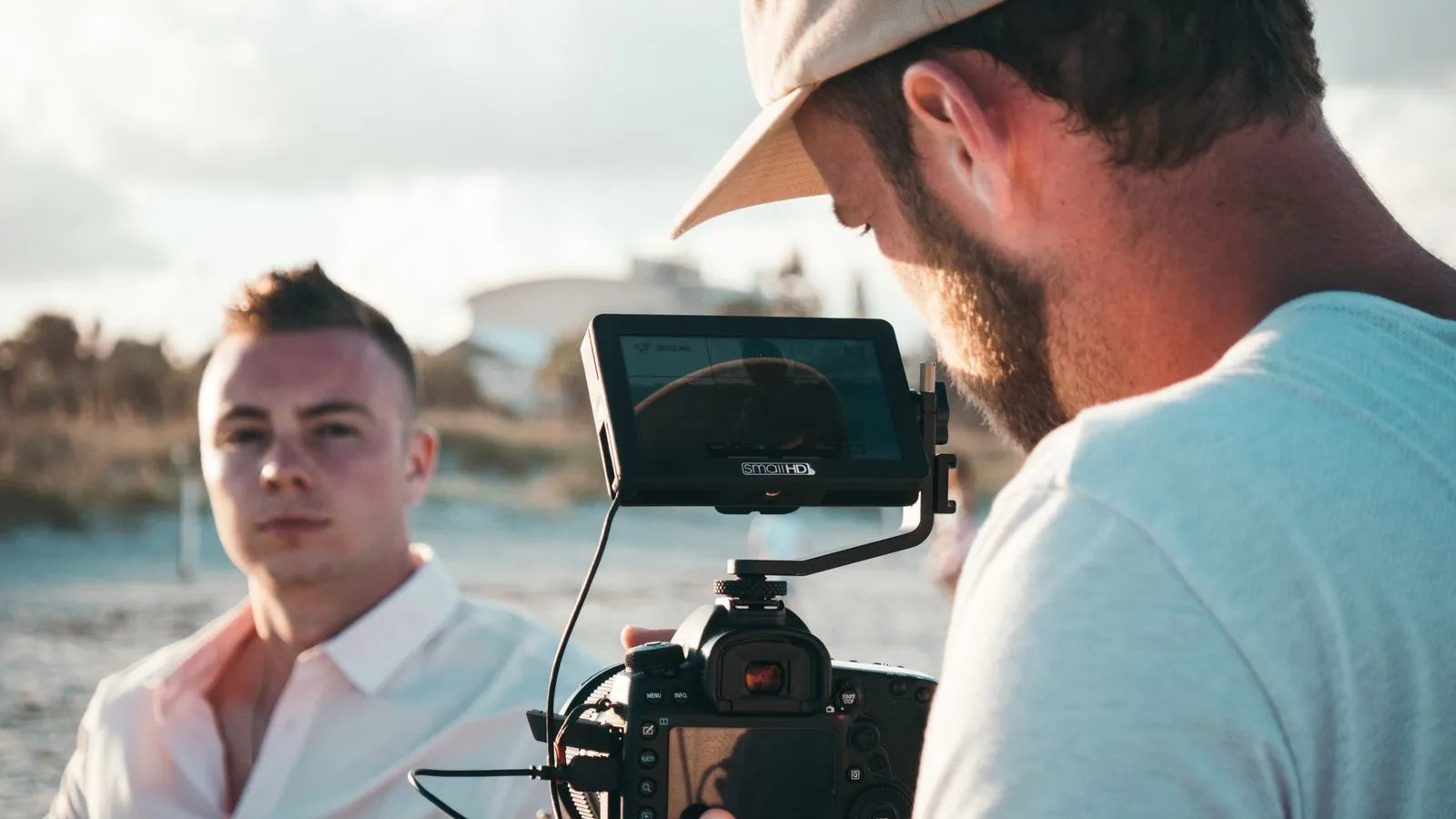 Filmmaker shooting a scene on a beach with a camera rig (illustration photo)