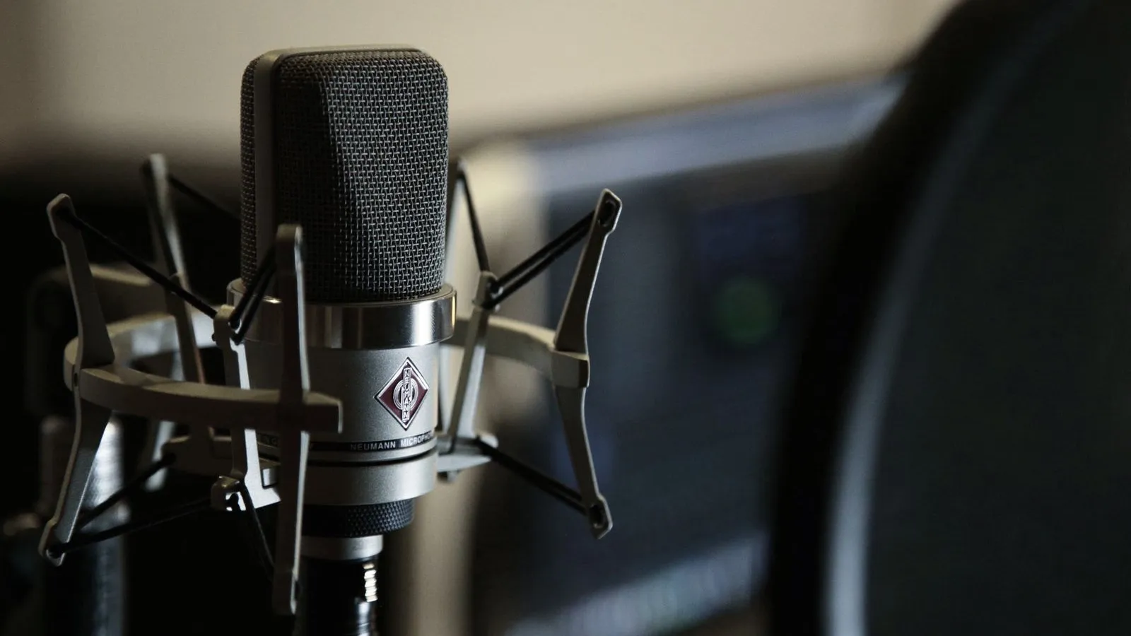 Condenser microphone in a shock mount in a recording studio